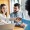 a couple at an office typing and shaking hands