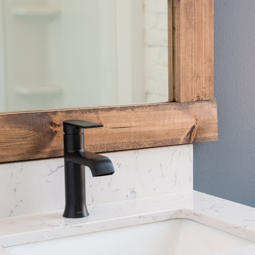 a bathroom faucet and a mirror