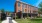 a large brick building and a black fence